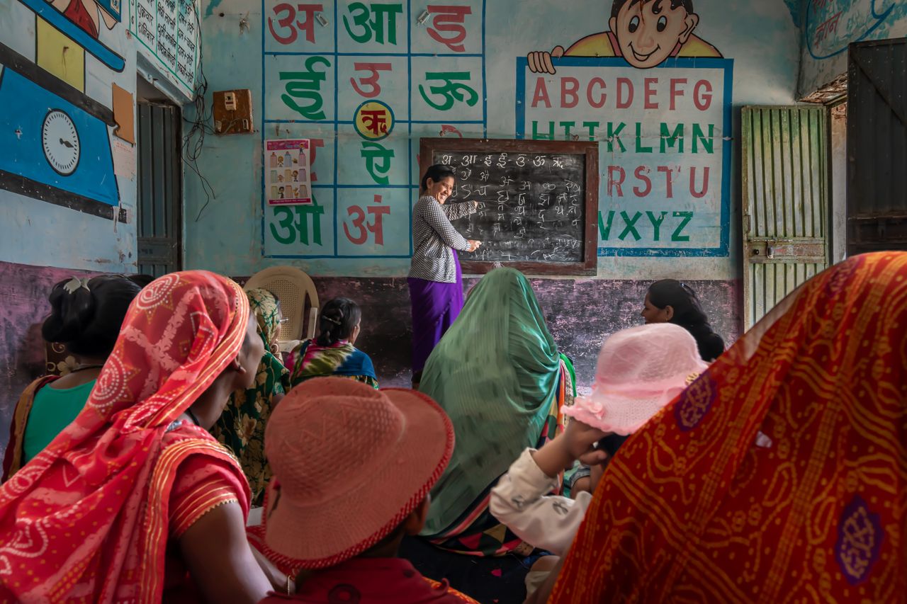 services-03 Women attending an educational session in a rural Indian classroom, promoting inclusivity and empowerment.
