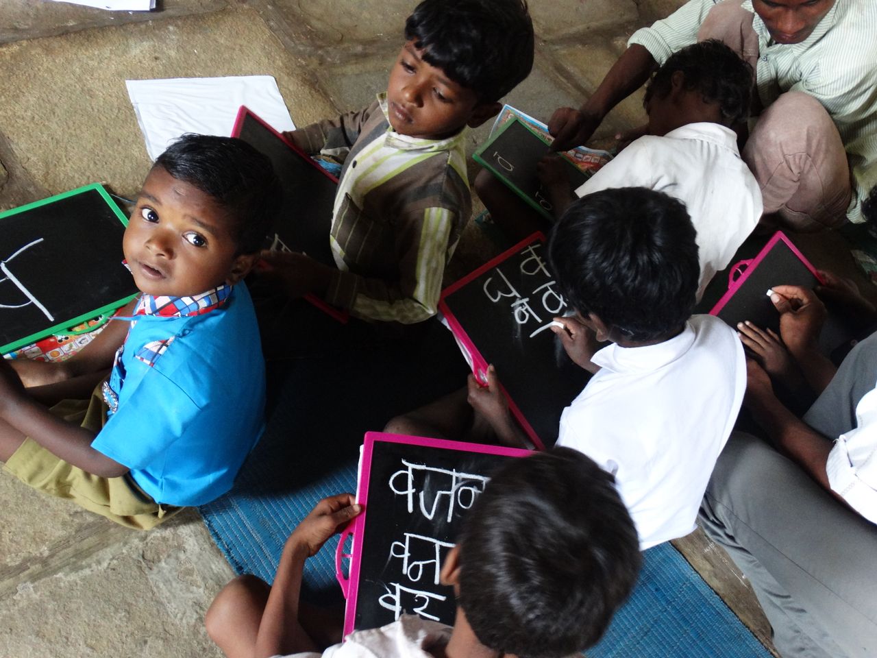 services-02 Young students writing on slates in a village school in Melghat, India.